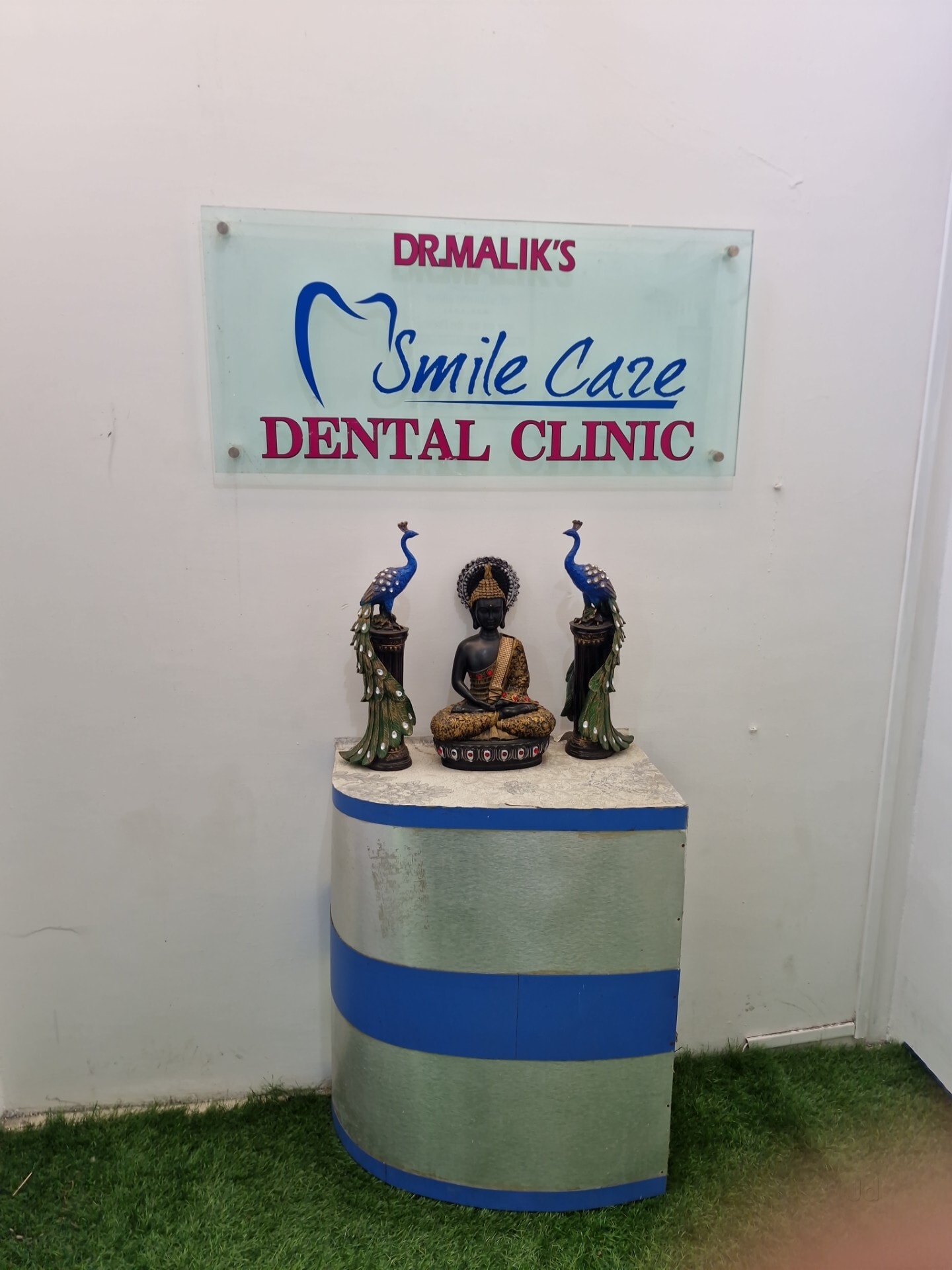 Smile Care Dental Clinic Ujjain reception sign board with Dr Malik